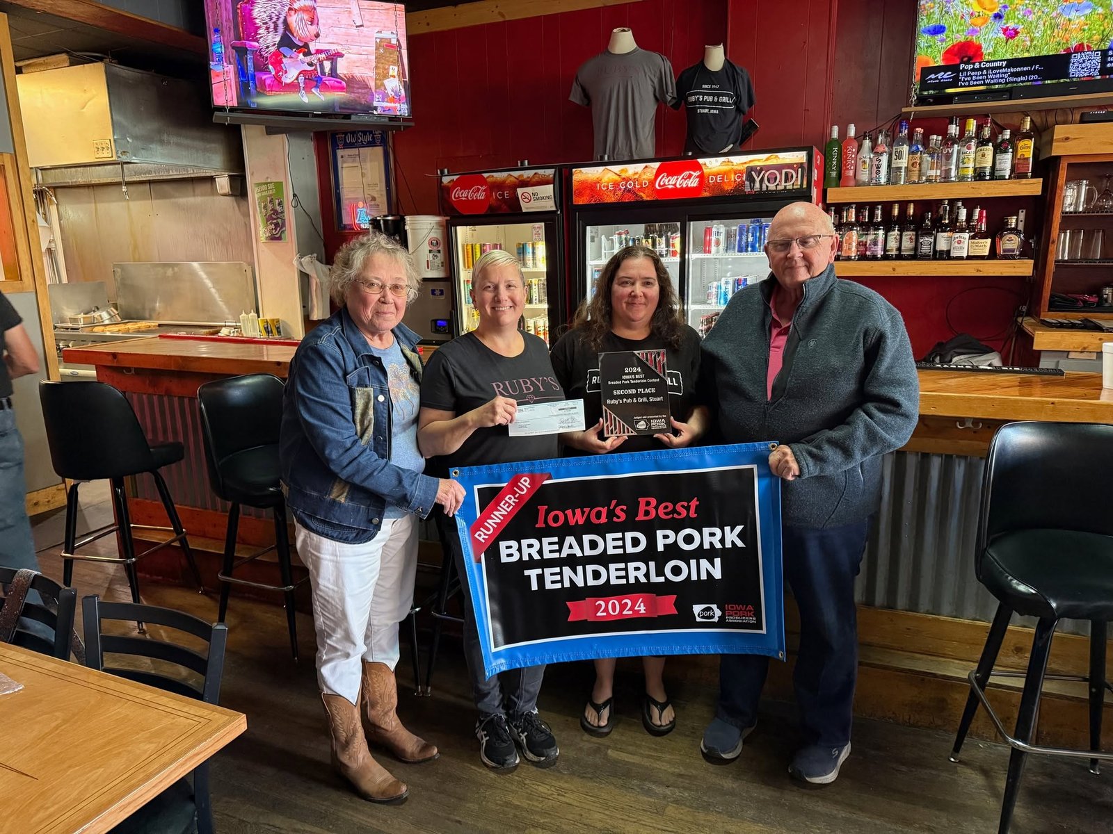 Jaime and Misty accepting Iowa's Best Breaded Pork Tenderloin Runner-Up 2024 banner