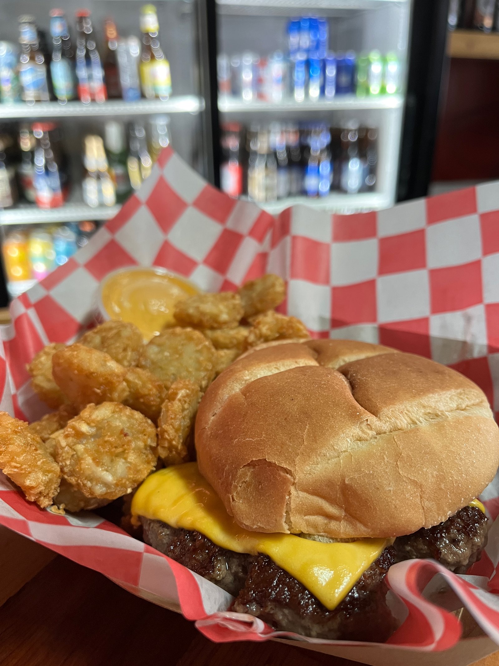 Burger and tots in a checkered basket at Ruby's