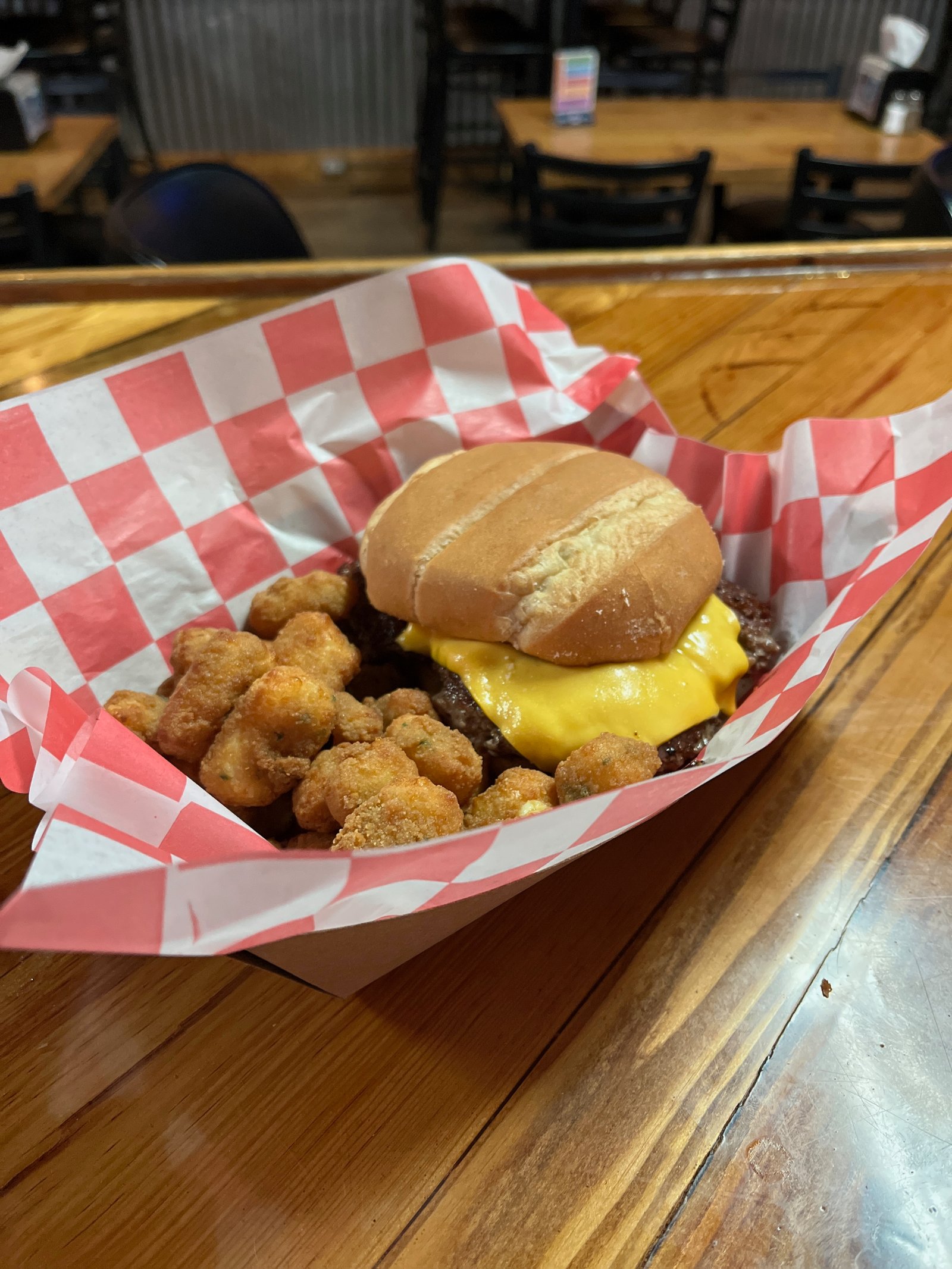 Cheeseburger with fries in checkered basket
